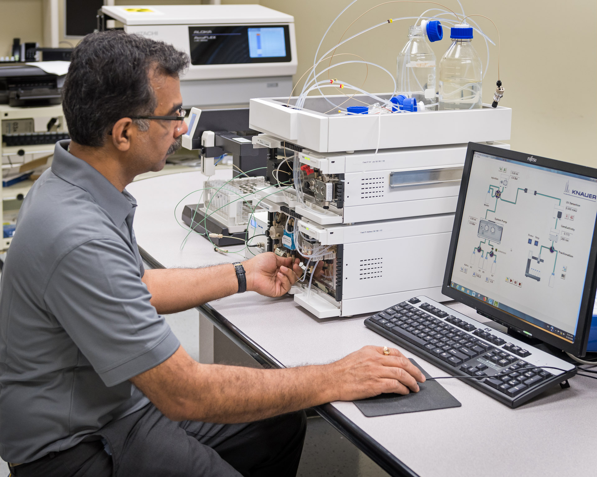 Technician recalibrating an HPLC system
