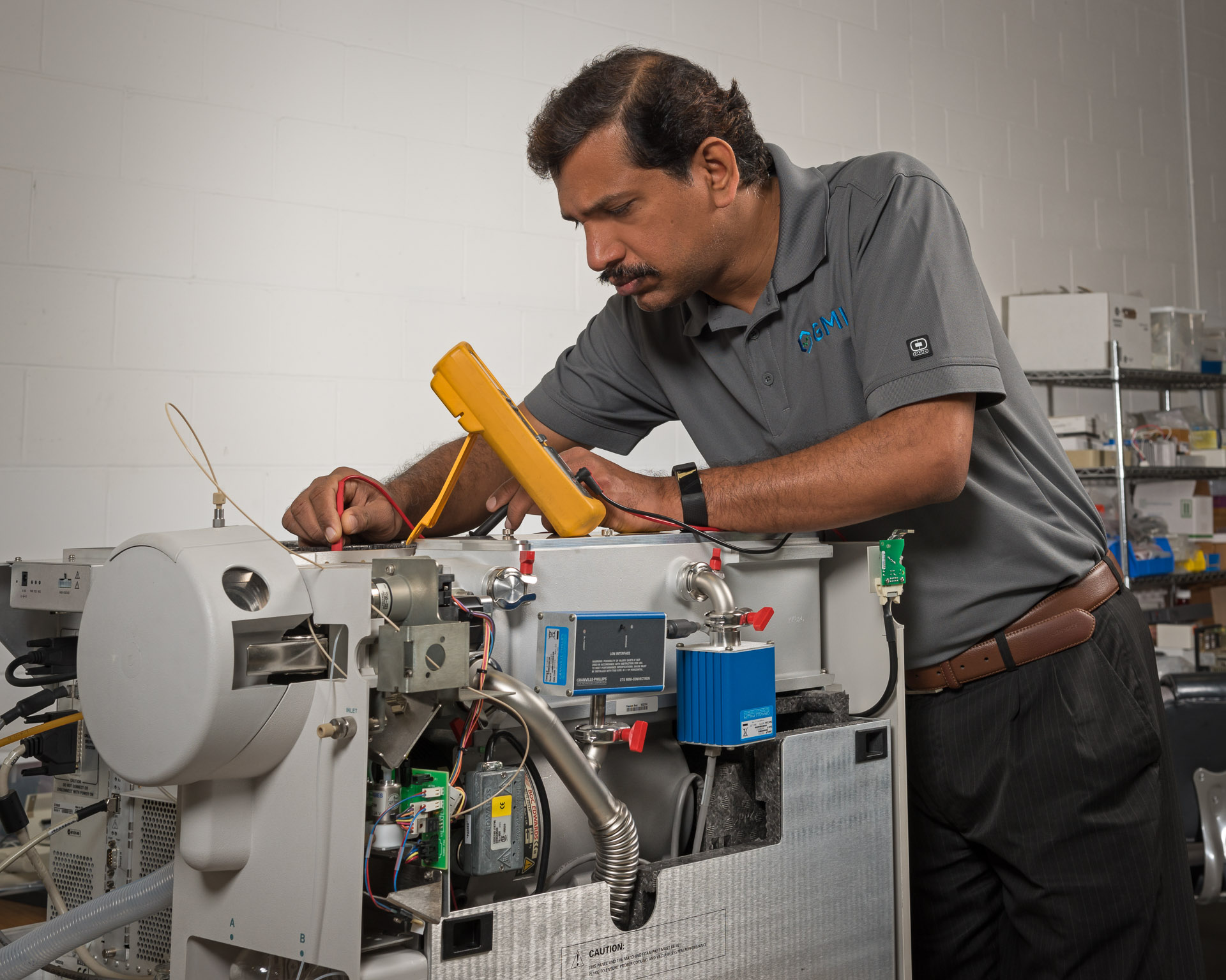 GMI field service engineer working on a laboratory instrument